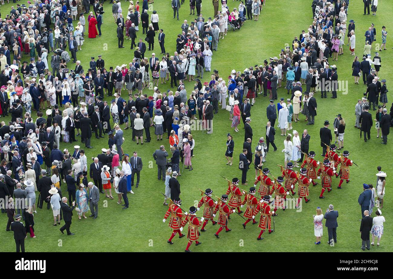 Guests attend a garden party at Buckingham Palace in London. Stock Photo