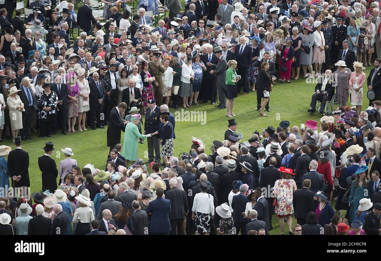 Queen Elizabeth II (centre left) meets guests during a garden party at Buckingham Palace in London. Stock Photo