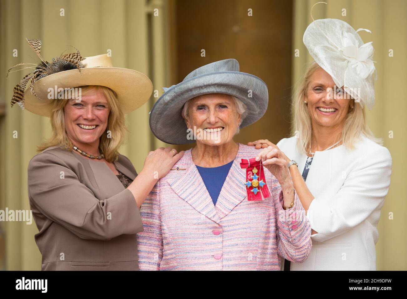 Producer Beryl Vertue, alongside her daughters Sue (left) and Debbie, with her Commander of the Order of the British Empire (CBE) medal, following an investiture ceremony at Buckingham Palace, London. Stock Photo