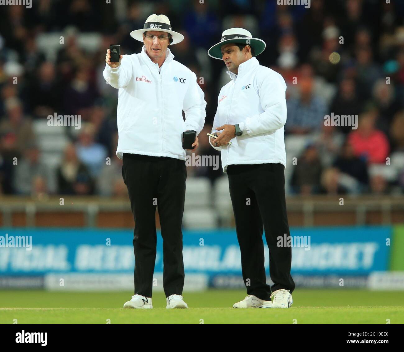 Umpires Aleem Dar and Rob Tucker take a light meter reading as the players leave the field for bad light during day two of the 1st Investec Test at Headingley, Leeds. Stock Photo