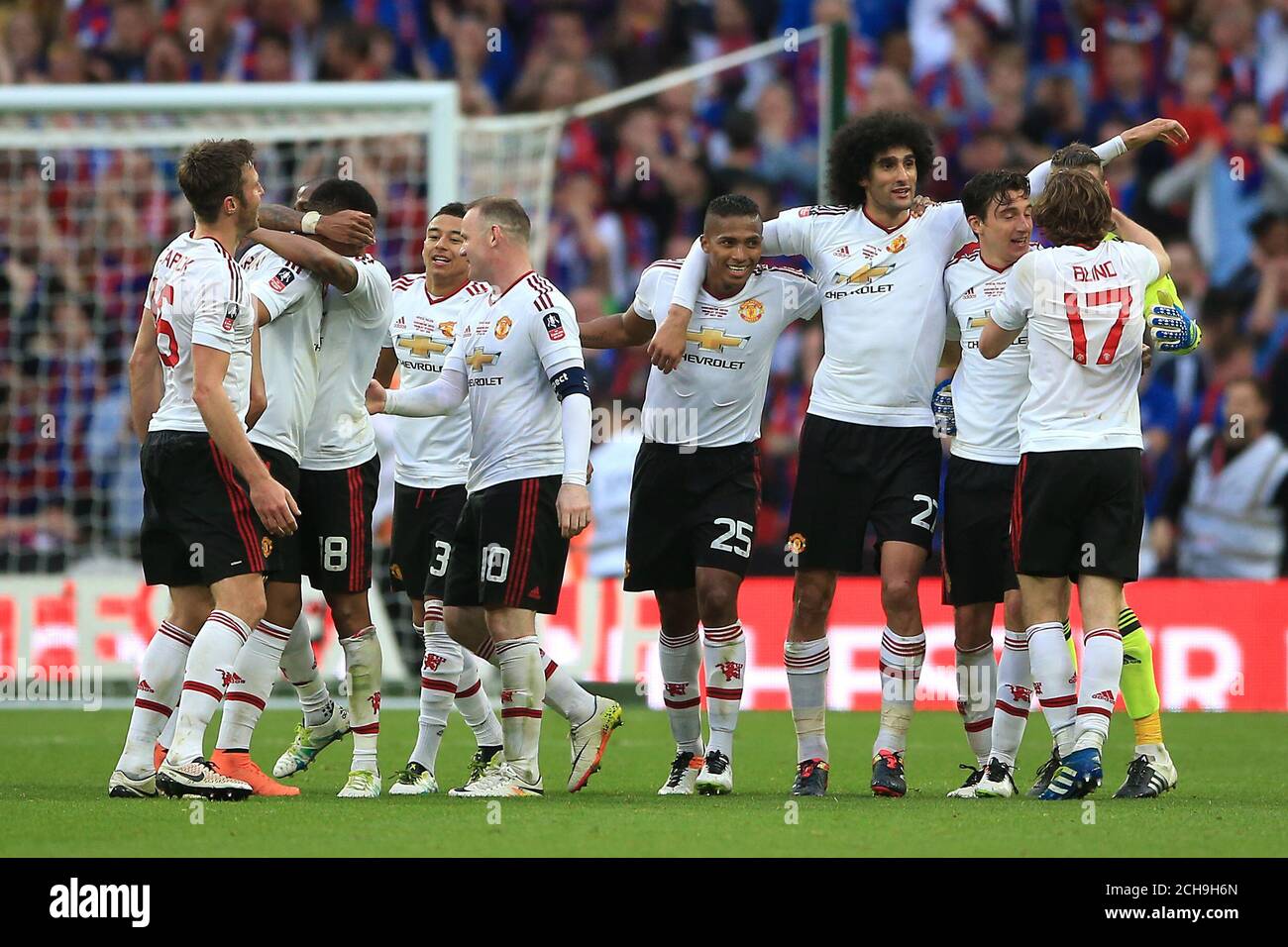 Manchester United players celebrate winning the Emirates FA Cup on the pitch after the final whistle during the Emirates FA Cup Final at Wembley Stadium