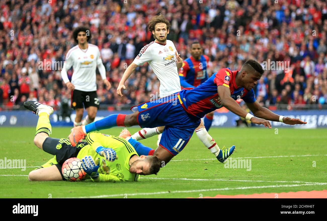 Manchester United goalkeeper David De Gea (left) claims the ball at the  feet of Crystal Palace's Wilfried Zaha during the Emirates FA Cup Final at  Wembley Stadium. PRESS ASSOCIATION Photo. Picture date:
