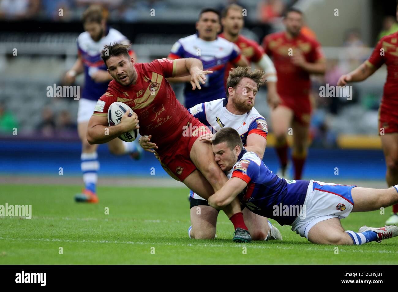 Catalan Dragons' Jason Baitieri is tackled by Wakefield Wildcat's Max Jowitt and Danny Kirmond during the Dacia Magic Weekend match at St James' Park, Newcastle. Stock Photo