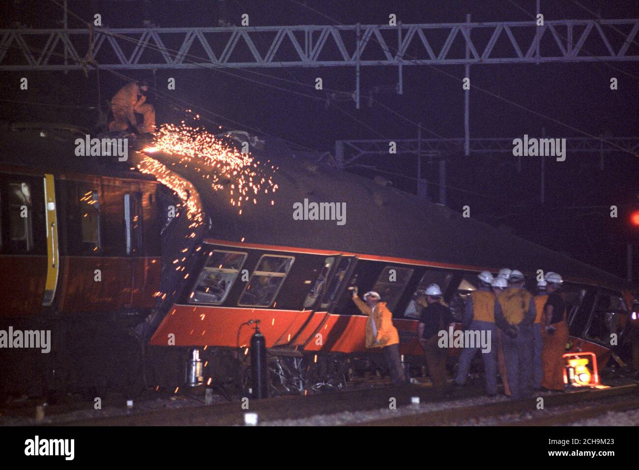 A rescue worker uses cutting equipment on one of the trains involved in