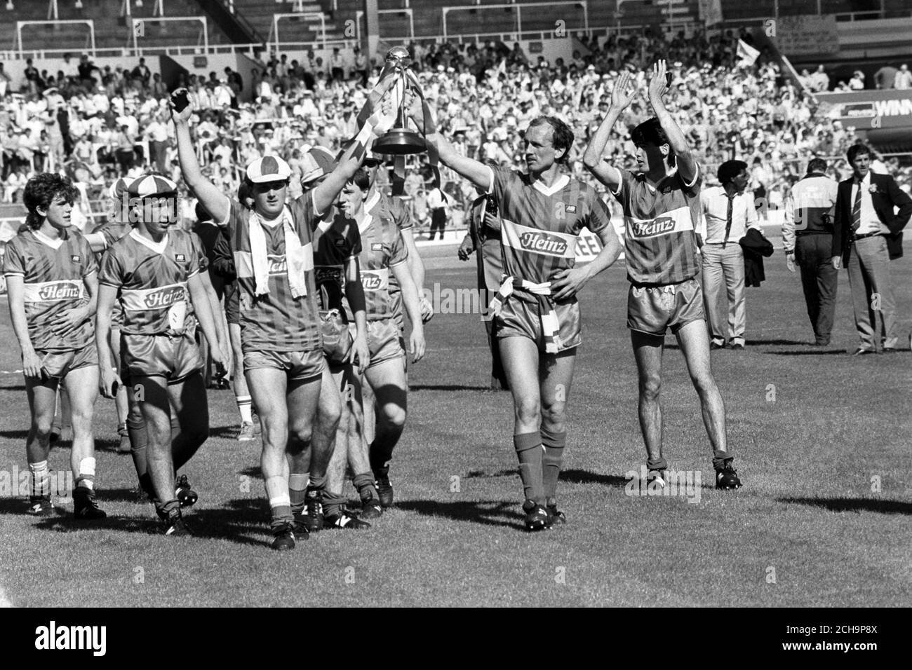 Wigan Athletic celebrate their victory at Wembley in the Football League Freight Rover Trophy Final against Brentford. Holding the trophy aloft is Tony Kelly (l), scorer of Wigan's second goal, and team captain Colin Methven (r). Wigan won 3-1. Stock Photo