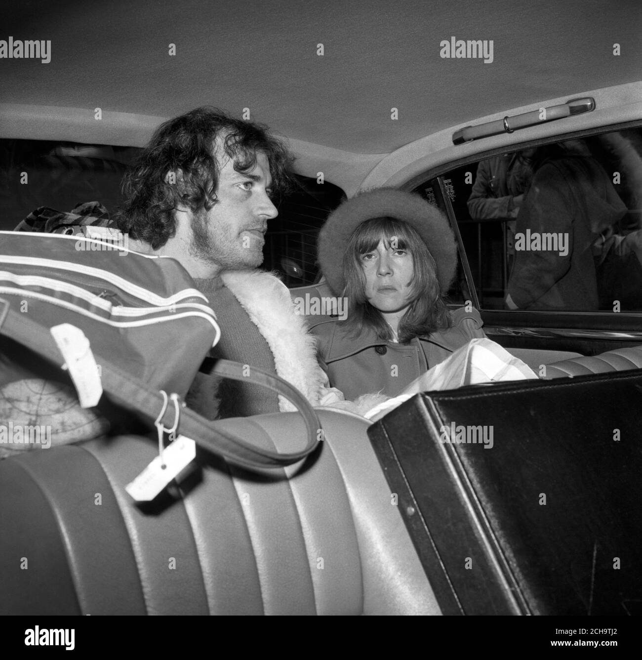 Joe Cocker, the British pop singer who was ordered out of Australia after being convicted of possessing drugs, drives away from Heathrow Airport with his girlfriend Eileen Webster. Stock Photo