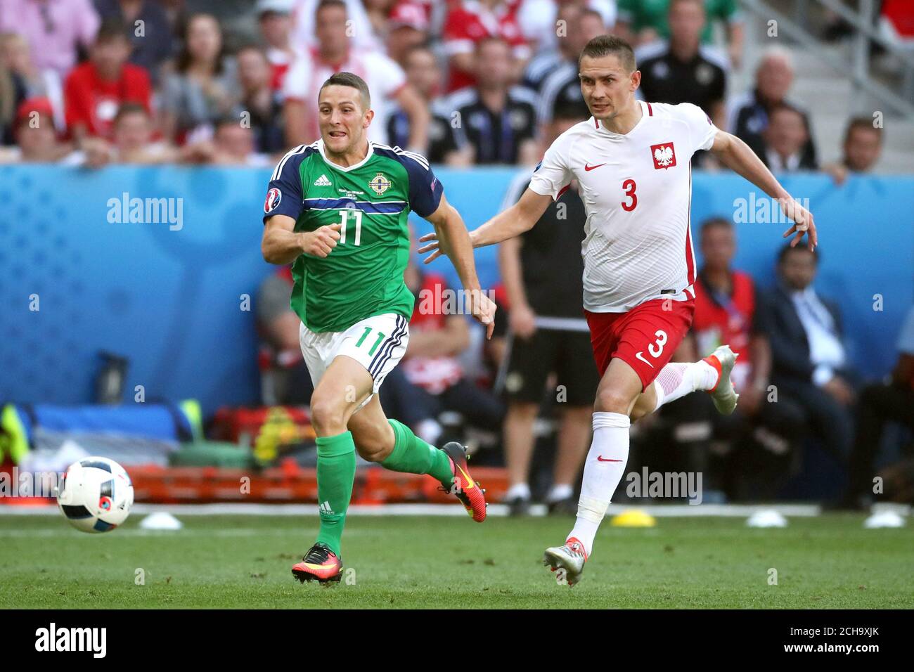 Northern Ireland's Conor Washington and Poland's Artur Jedrzejczyk (right) battle for the ball Stock Photo