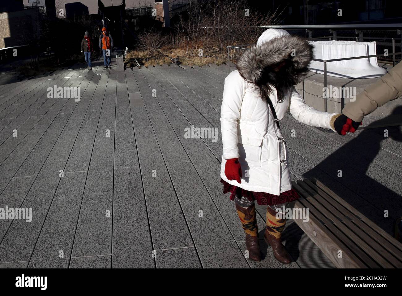 People walk along the High Line in the Manhattan borough of New York February 14, 2016. Temperatures dipped to well below freezing on Sunday with meteorologists dubbing the weather phenomenon as being a polar vortex. REUTERS/Andrew Kelly Stock Photo