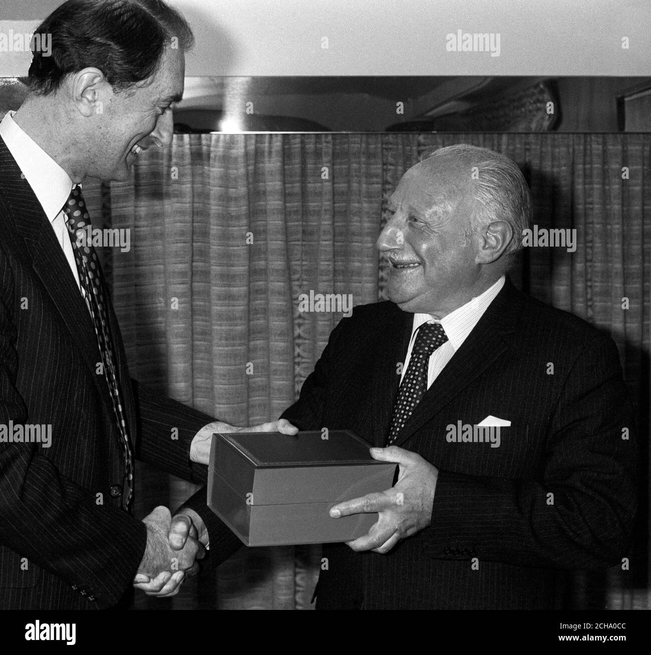 Racing journalist Bill Garland (r) is handed a retirement gift by Press Association general manager Ian Yates. Stock Photo