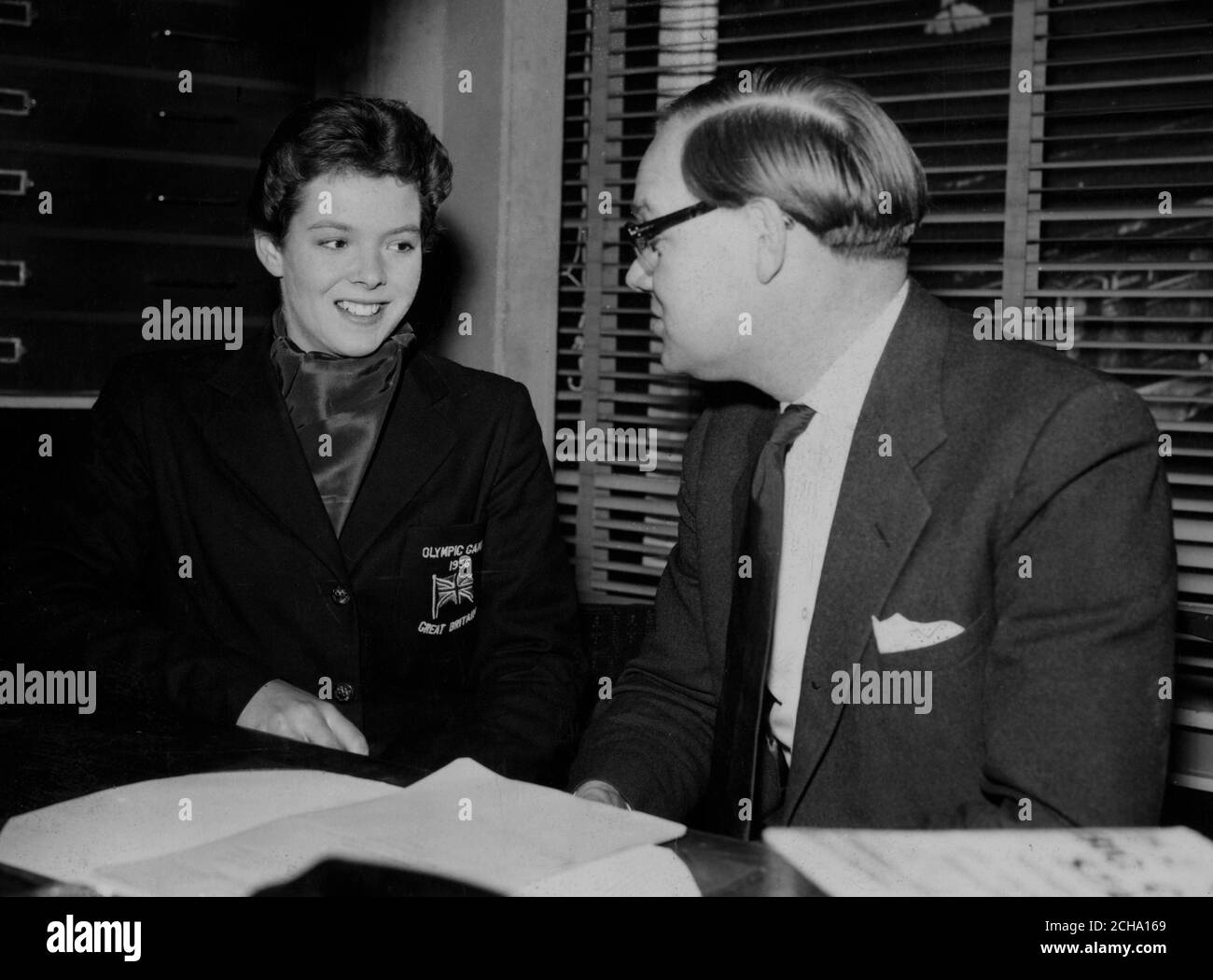 Great Britain's first Olympic gold medal swimmer for 36 years, 17-year-old Judy Grinham, who is interviewed by Cliff Michelmore for BBC Television's 'Junior sportsview' programme. *Neg corrupt. Scanned from contact Stock Photo