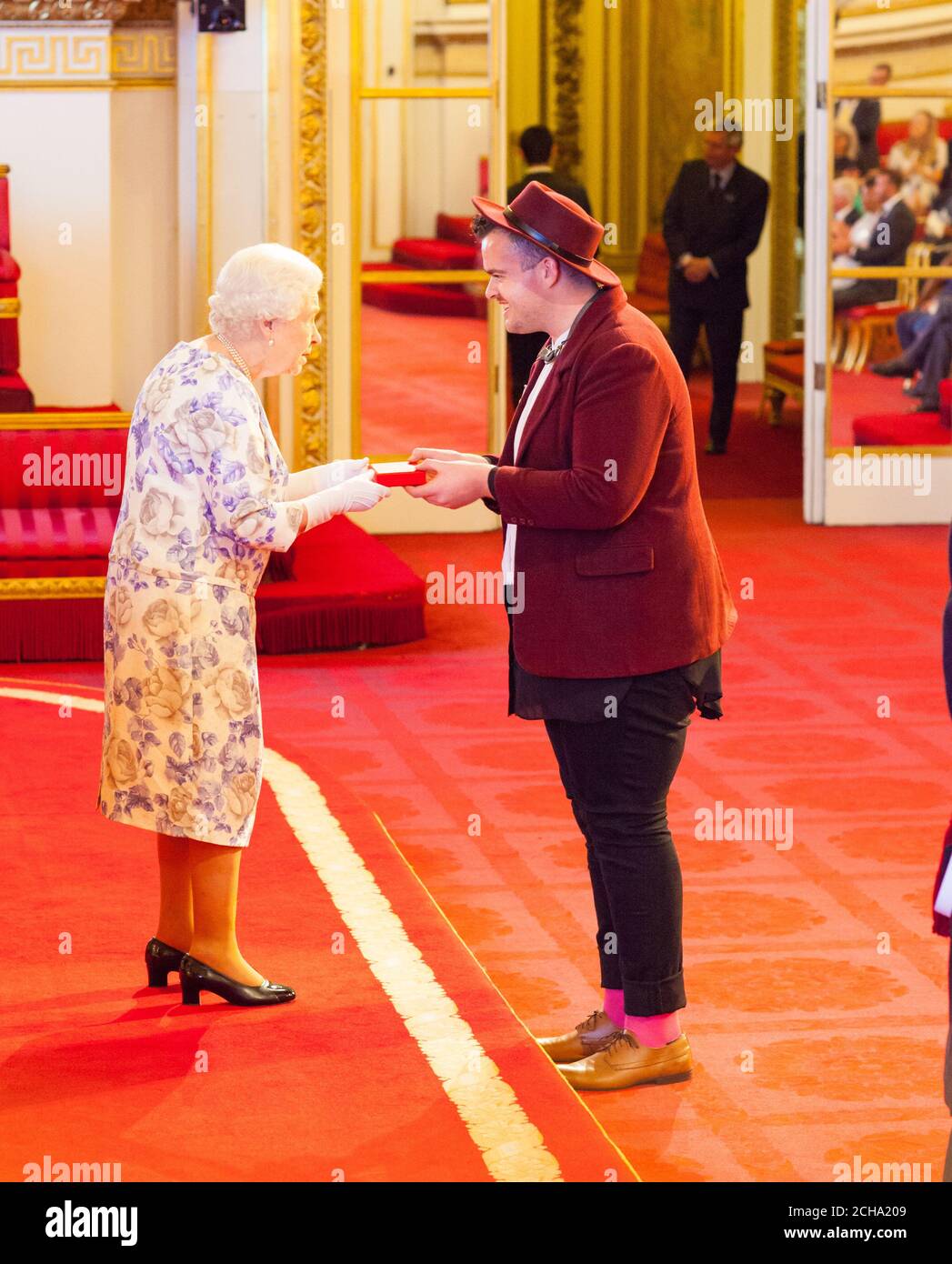 Mx. Jacob Thomas from Australia receives a medal from Queen Elizabeth II during the Queen's Young Leaders Awards 2016 at Buckingham Palace, London. PRESS ASSOCIATION Photo. Picture date: Thursday June 23, 2016. Photo credit should read: Dominic Lipinski/PA Wire Stock Photo