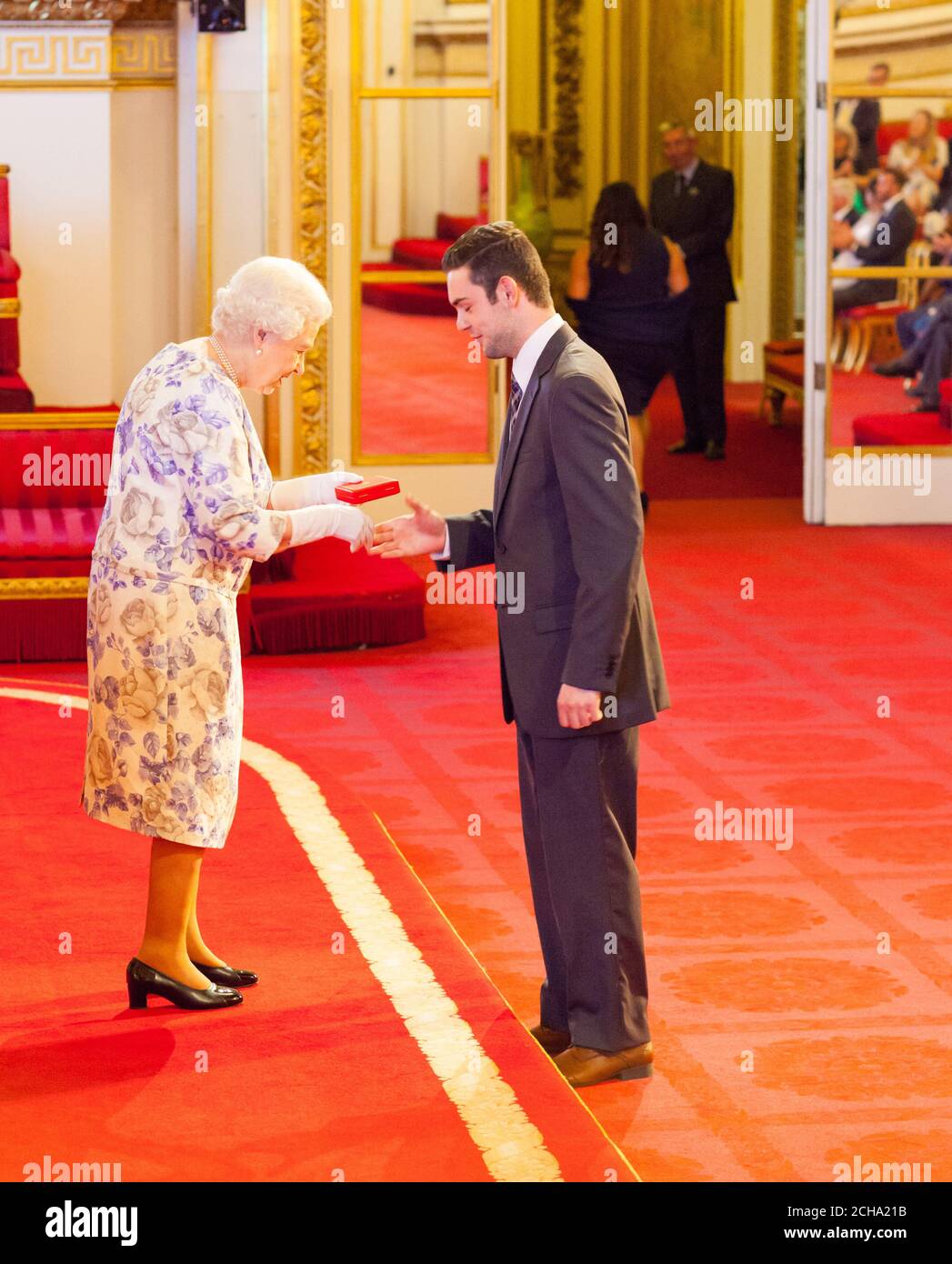 Mr. Alexander Stonyer-Dubinovsky from Australia receives a medal from Queen Elizabeth II during the Queen's Young Leaders Awards 2016 at Buckingham Palace, London. PRESS ASSOCIATION Photo. Picture date: Thursday June 23, 2016. Photo credit should read: Dominic Lipinski/PA Wire Stock Photo