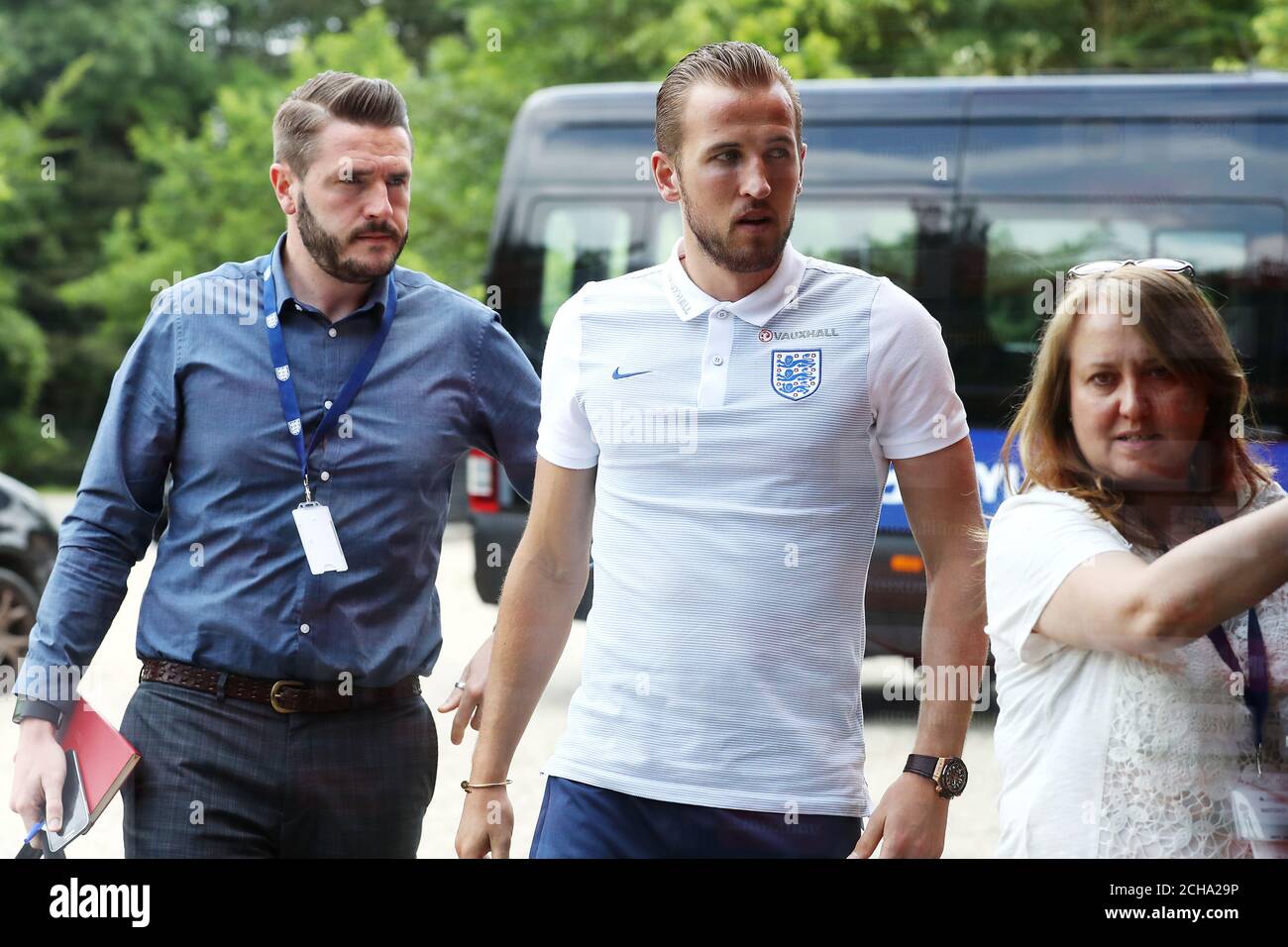 England's Harry Kane (centre) arrives for a press conference with the FA's Senior Communications Manager Andy Walker (left) and head of media operations Joanne Budd (right) at Les Fontaines, Chantilly. PRESS ASSOCIATION Photo. Picture date: Friday June 24, 2016. See PA story SOCCER England. Photo credit should read: Owen Humphreys/PA Wire. Stock Photo