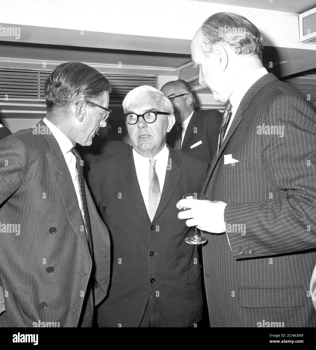 Lord Hill, Chairman of the Independent Television Authority (centre) taking with Mr Allan G Stephen, Chairman of the Press Association (right), and Mr AM Burnett-Stuart, the Chairman-elect, at the Press Association luncheon at the Savoy Hotel, London. Lord Hill was the guest of honour. Stock Photo