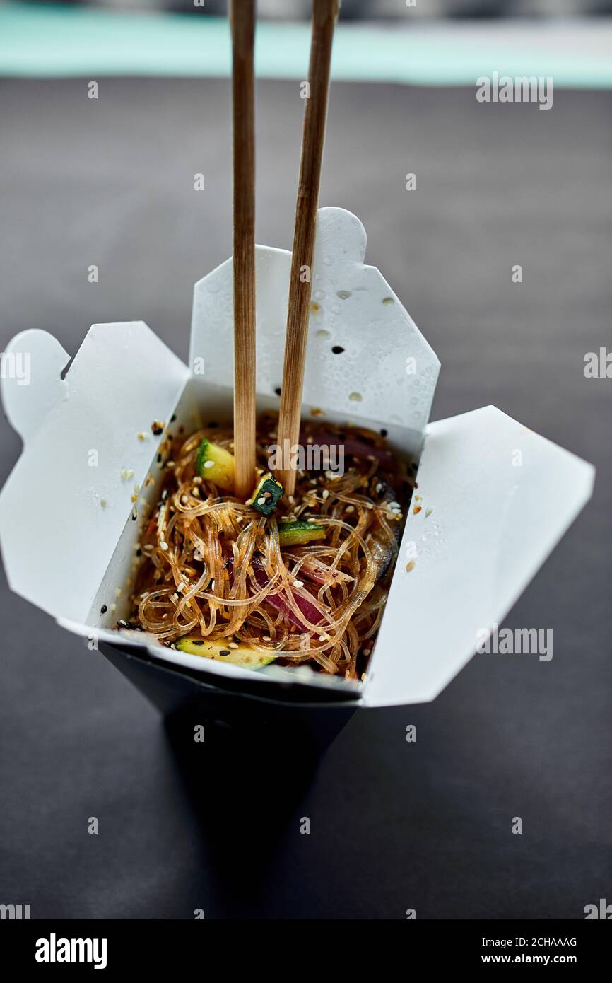 Tasty Udon noodles pasta with tempuru, shrimps wok in box delivery