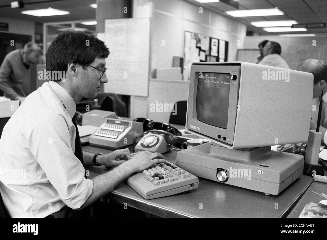 Jonathan Grun using a Coyote computer in the Press Association newsroom. Stock Photo