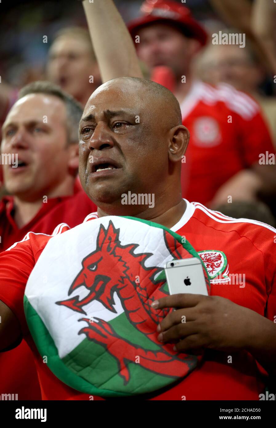 A Wales fan shows his emotion in the stands after the UEFA Euro 2016, semi-final match at the Stade de Lyon, Lyon. Stock Photo