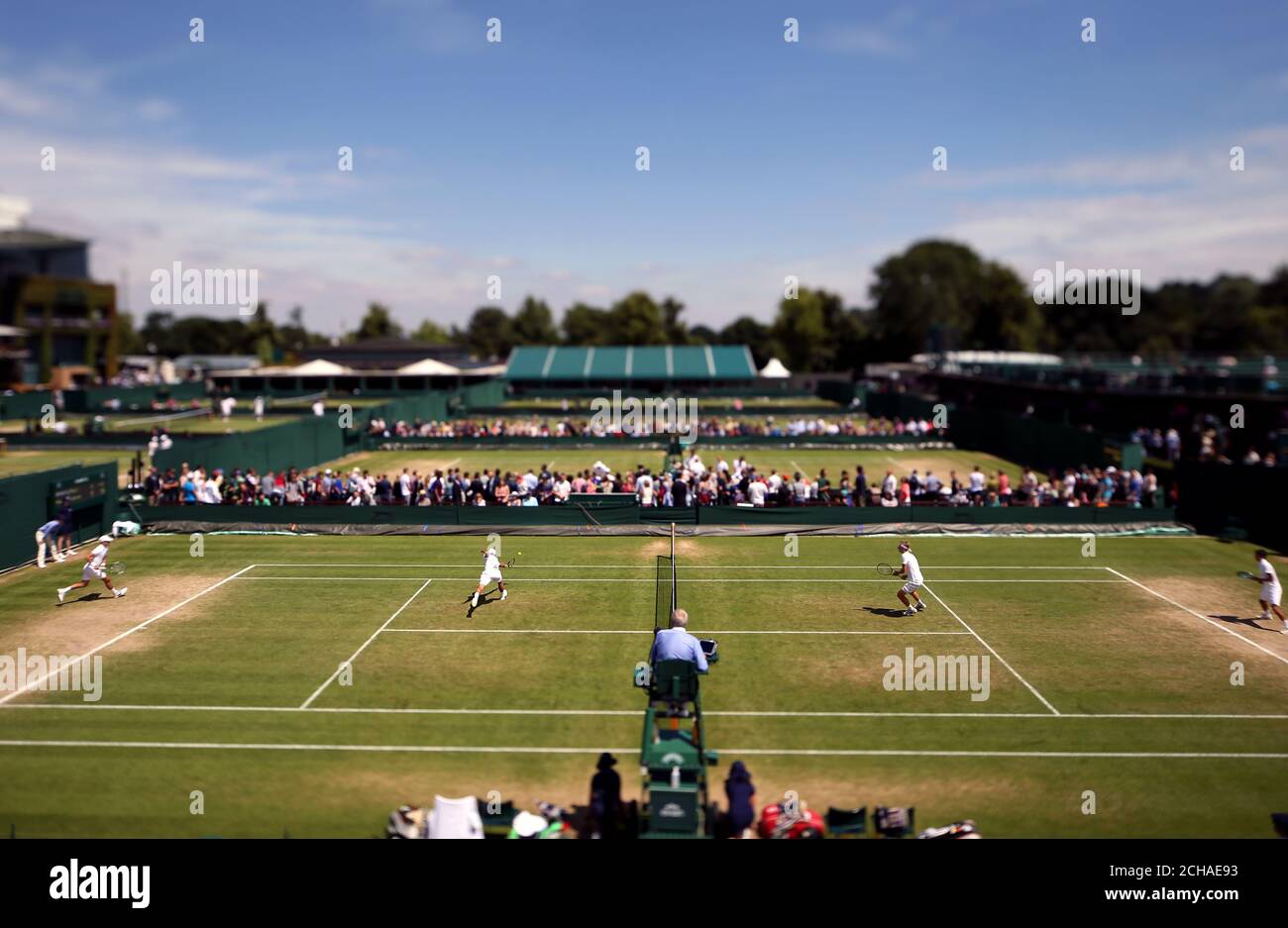 General view across the outside courts as Youssef Hossam and Ergi Kirkin play boys doubles against Alejandro Davidovich Fokina and Alexei Popyrin on day ten of the Wimbledon Championships at the All England Lawn Tennis and Croquet Club, Wimbledon. Stock Photo