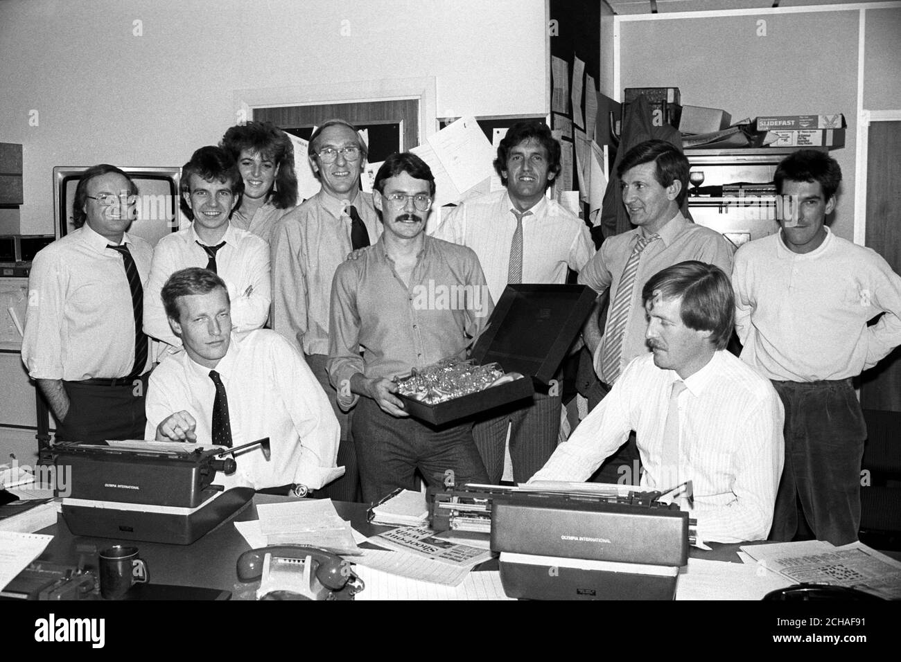 PA Athletics correspondent John Burton holds a set of crystal claret glasses presented to him by colleagues on his last day at the national news agency before leaving to join a Fleet Street newspaper. Burton had been at PA since 1978. Stock Photo