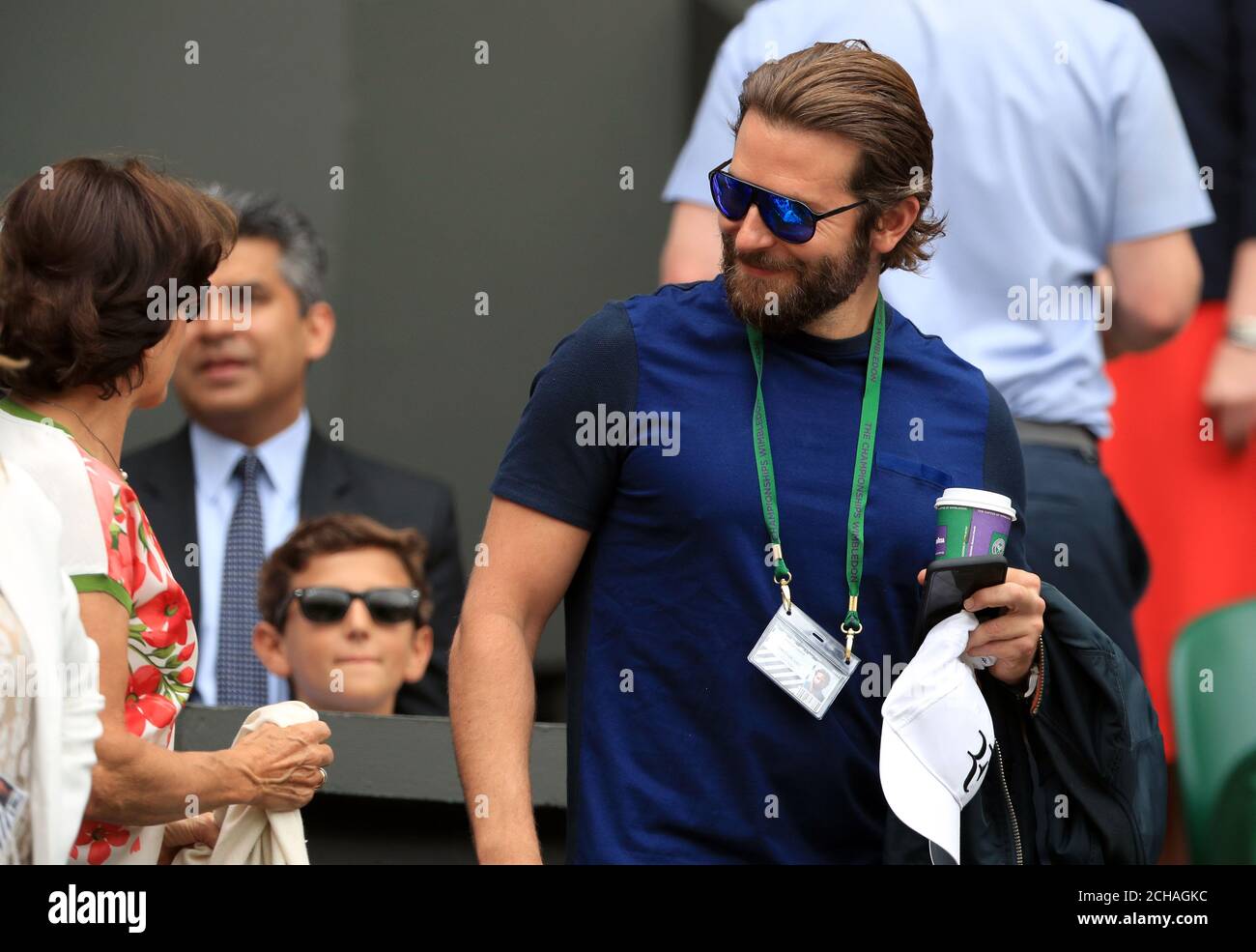 Lynette Federer greets Bradley Cooper in Roger Federer's players box on day eleven of the Wimbledon Championships at the All England Lawn Tennis and Croquet Club, Wimbledon. Stock Photo