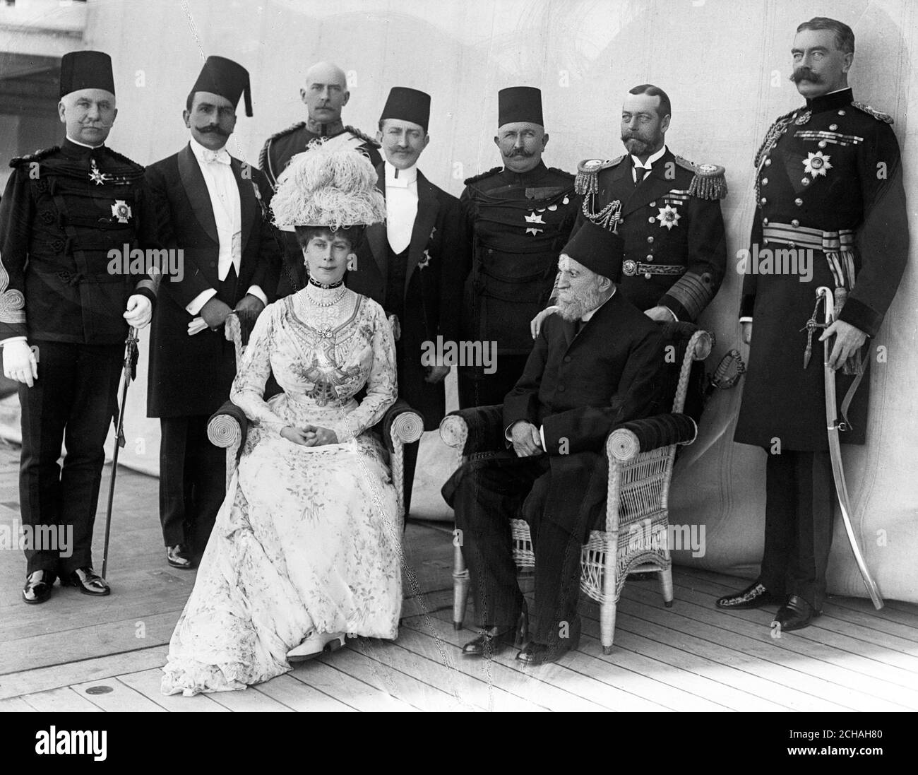 On board the 'Medina' outward journey. (Back row, l-r) General Sir Reginald Wingate (Sirdar of Egypt), H.H. Prince Muhammad Ali Pasha, the Duke of Teck, Prince Zia-ed-Din, the Khedive of Egypt, King George V and Lord Kitchener. (Front, l-r) Queen Mary and H.H. Kiamil Pasha ( Ex Grand Vizier of Turkey). Stock Photo