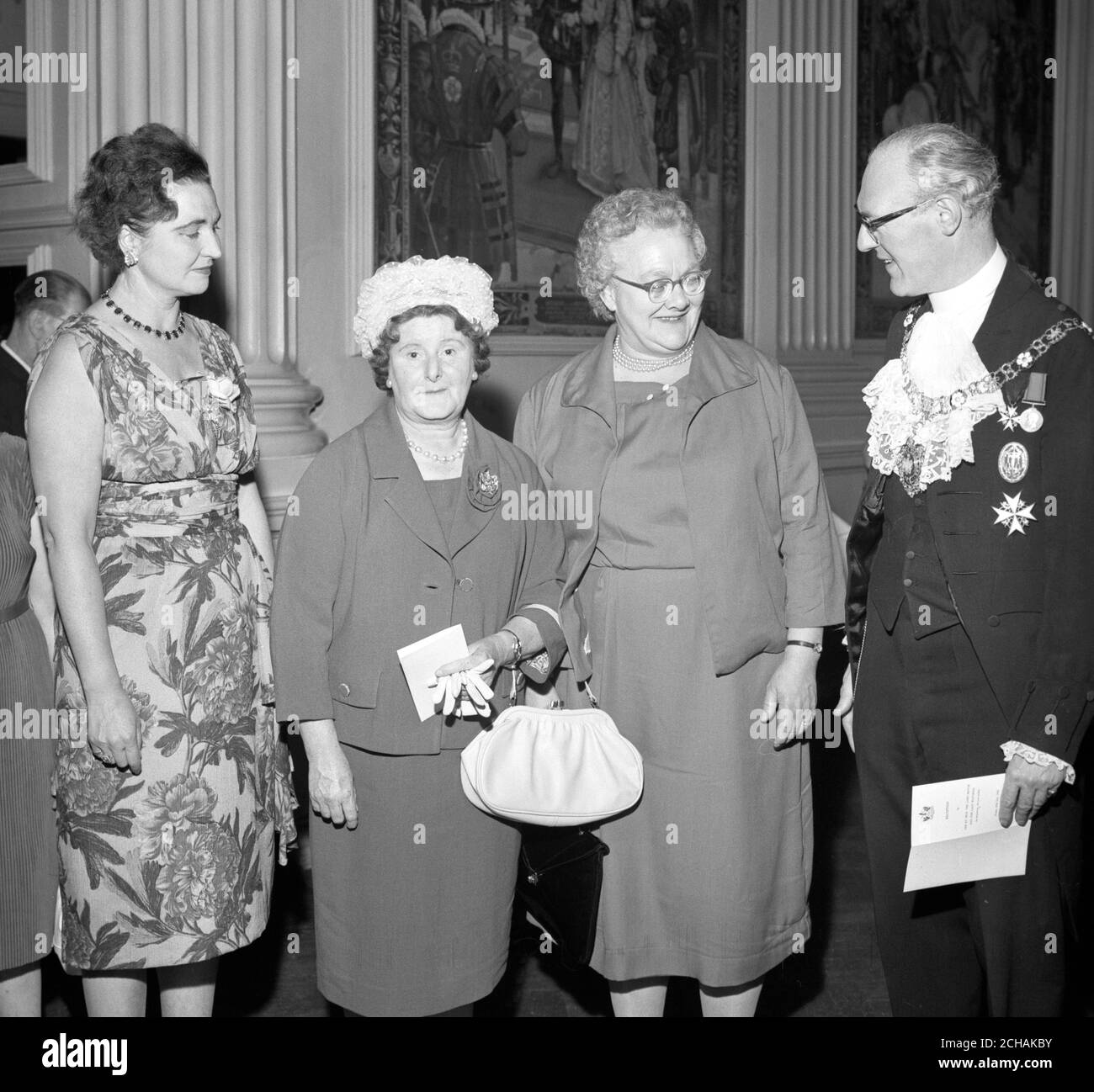 The Lord Mayor of London Sir Frederick Hoare chatting with Press Association cleaners Mrs Twigg (second right), and Mrs Whiterod (second left), when he and the Lady Mayoress entertained about 400 of the City's female cleaners at a reception in Mansion House. The reception, in connection with the City of London Festival, was given by the Lord Mayor and his wife because they felt that some tribute ought to be paid to those who keep the City and its offices clean. Stock Photo