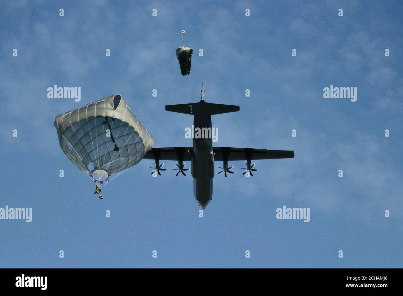 U.S. Army Reserve paratroopers from the 416th Civil Affairs Battalion (Airborne) conduct airborne operations from a C-130 aircraft over Edwards Air Force Base, Calif., Feb. 22, 2020. Soldiers assigned to airborne units must complete a parachute jump every three months to retain jump certification and proficiency. (U.S. Army Reserve photo by Master Sgt. Alec Appleton) Stock Photo