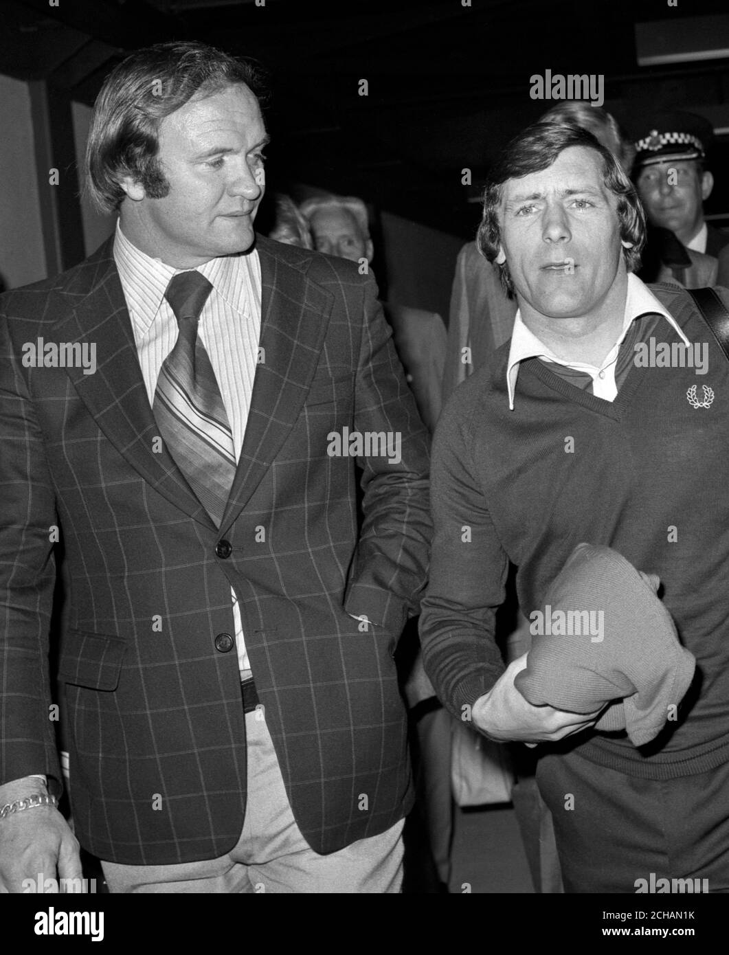 Scottish soccer star, Willie Johnston (r), 31, ao arrival at Heathrow Airport, London, where he was greeted by West Bromwich Albion manager Ron Atkinson, who supporting the player after he was banned for life from playing for Scotland after testing positive for a banned stimulant. Stock Photo