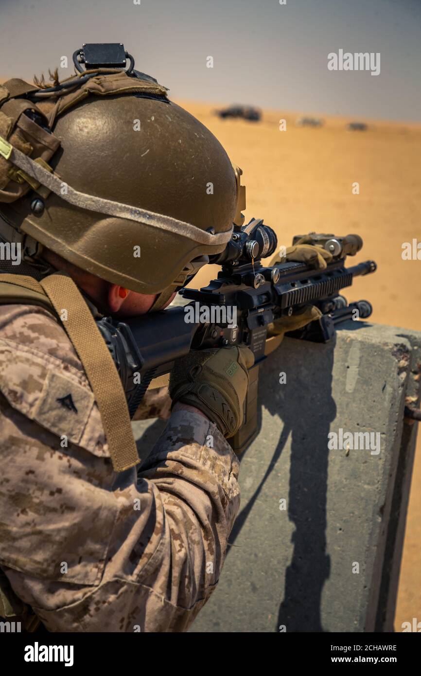 A U.S. Marine with 2nd Battalion, 5th Marine Regiment, with Special Purpose Marine Air-Ground Task Force Crisis Response - Central Command 20.2, provides cover fire with his M27 infantry automatic rifle during an anti-armor range in Kuwait, Sept. 3, 2020. The training focused on integrating anti-armor capabilities at the platoon level. The SPMAGTF-CR-CC is a crisis response force, prepared to deploy a variety of capabilities across the region. (U.S. Marine Corps photo by Lance Cpl. Andrew Skiver) Stock Photo