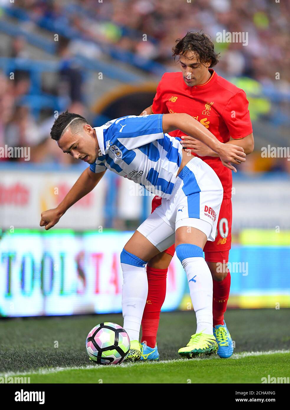 Huddersfield Town's Jason Davidson (left) and Liverpool's Lazar Markovic battle for the ball. Stock Photo