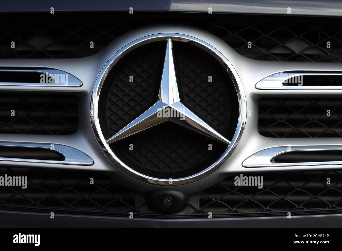 General view of a Mercedes car badge on the front grill of a car Stock Photo