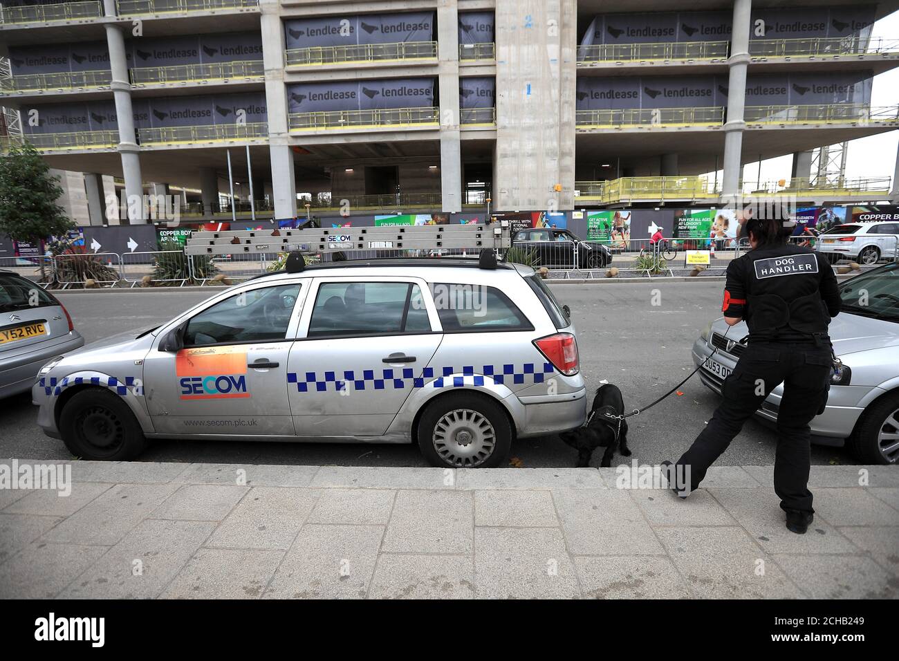 A security dog handler check cars outside the London Stadium Stock ...