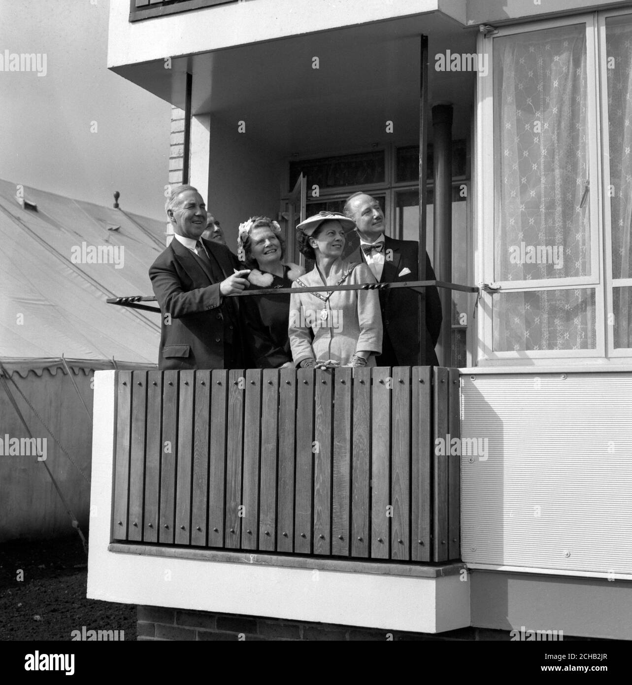Minister of Housing Henry Brooke and members of his party on the balcony of one of the two 13-storey blocks of flats at Highview Gardens, New Southgate, London. (L-R) Henry Brooke and his wife, Francis J.V. Brown, Mayoress of Southgate, and David du R. Aberdeen, the architect. Stock Photo