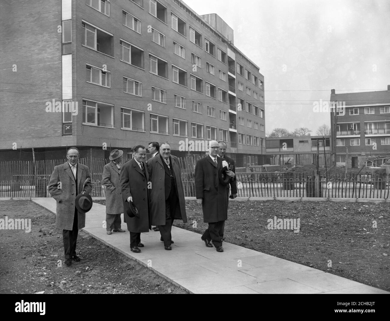 Herr Paul Lucke, Federal German Minister of Housing (second from left, hat in hand) is accompanied by E.E. Woods (third from left), vice-chairman of the London County Council, during a visit to Cornish House, a newly-completed 18-storey block of three-room flats in Southwark, London. Stock Photo
