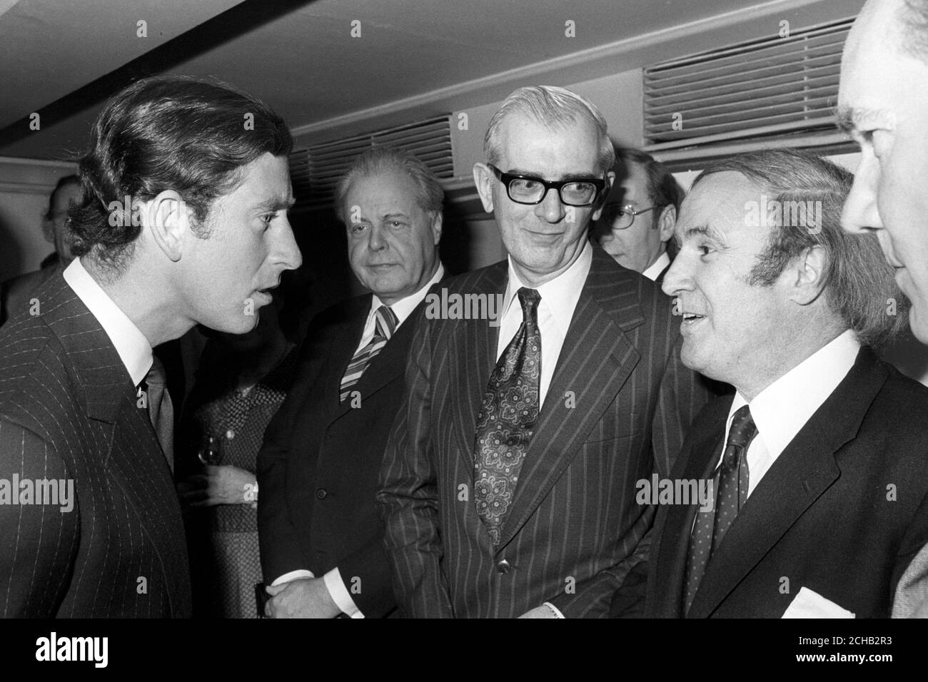 Prince Charles, who was presenting the British Press Awards, chats to one of the judges, David Chipp (r), Editor-in-Chief of the Press Association, before the presentation ceremony at the Savoy Hotel in London. Stock Photo