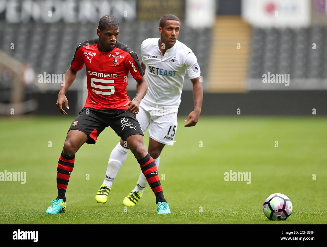 Stade Rennais's Ludovic Baal holds off Swansea City's Wayne Routledge Stock Photo