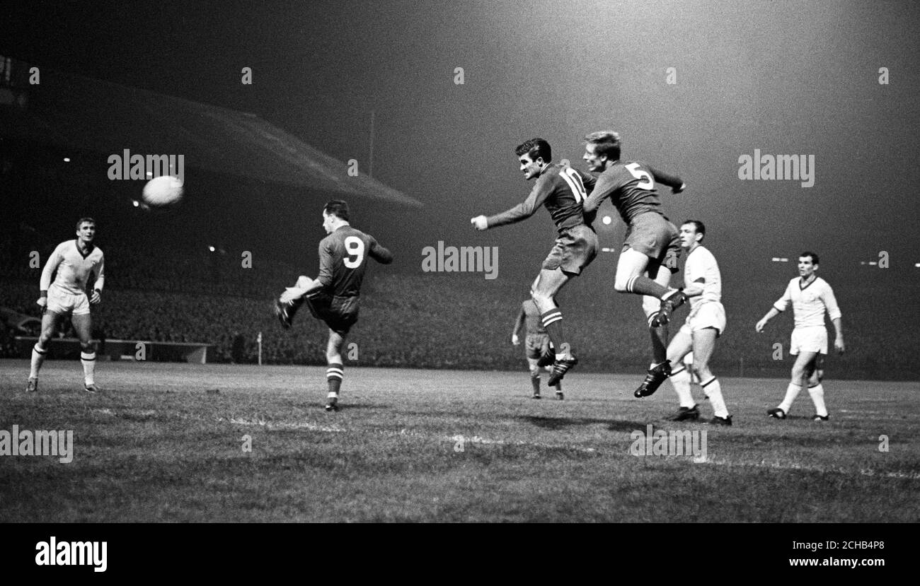 Celtic attack in an attempt to save their European Cup tie against Dynamo Kiev as Celtic's Stevie Chalmers (centre) skips in as Bertie Auld heads the ball and is covered by Celtic team-mate Billy McNeill (5). Celtic lost the match 1-2. Stock Photo