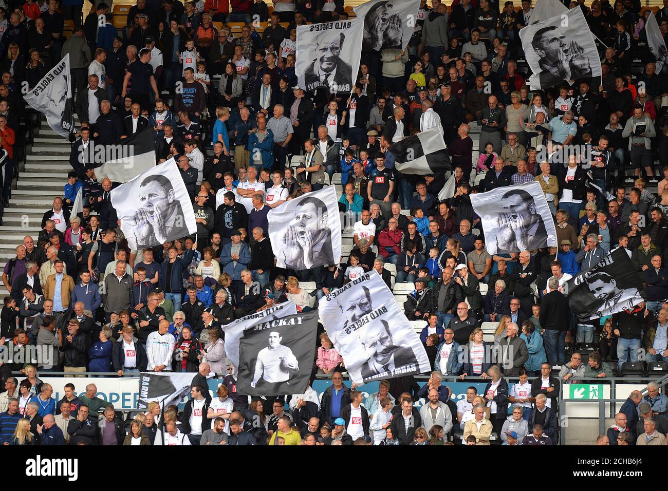 Derby County fans hold aloft flags of their former managers Stock Photo