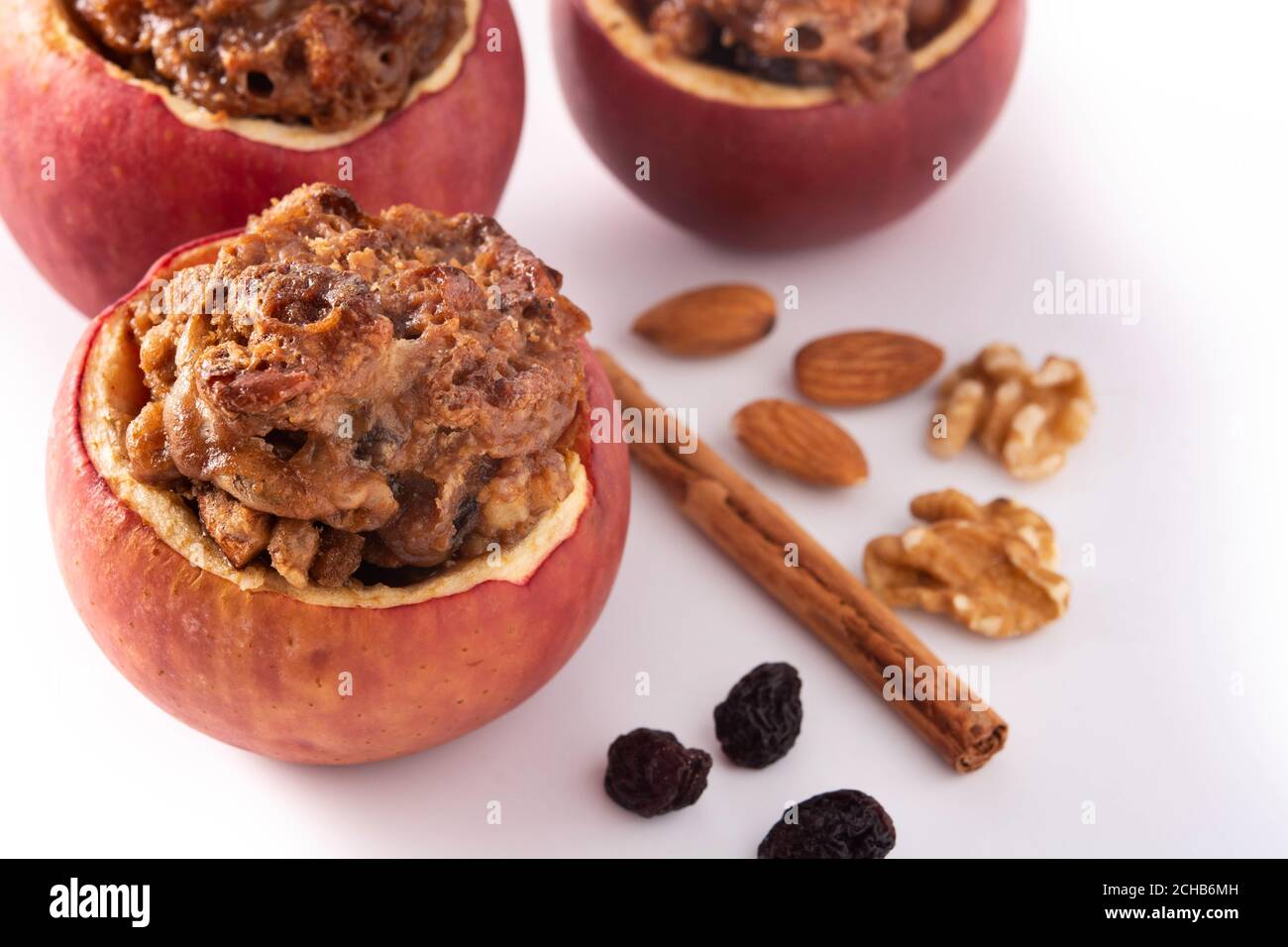Stuffed apples baked with nuts isolated on white background Stock Photo