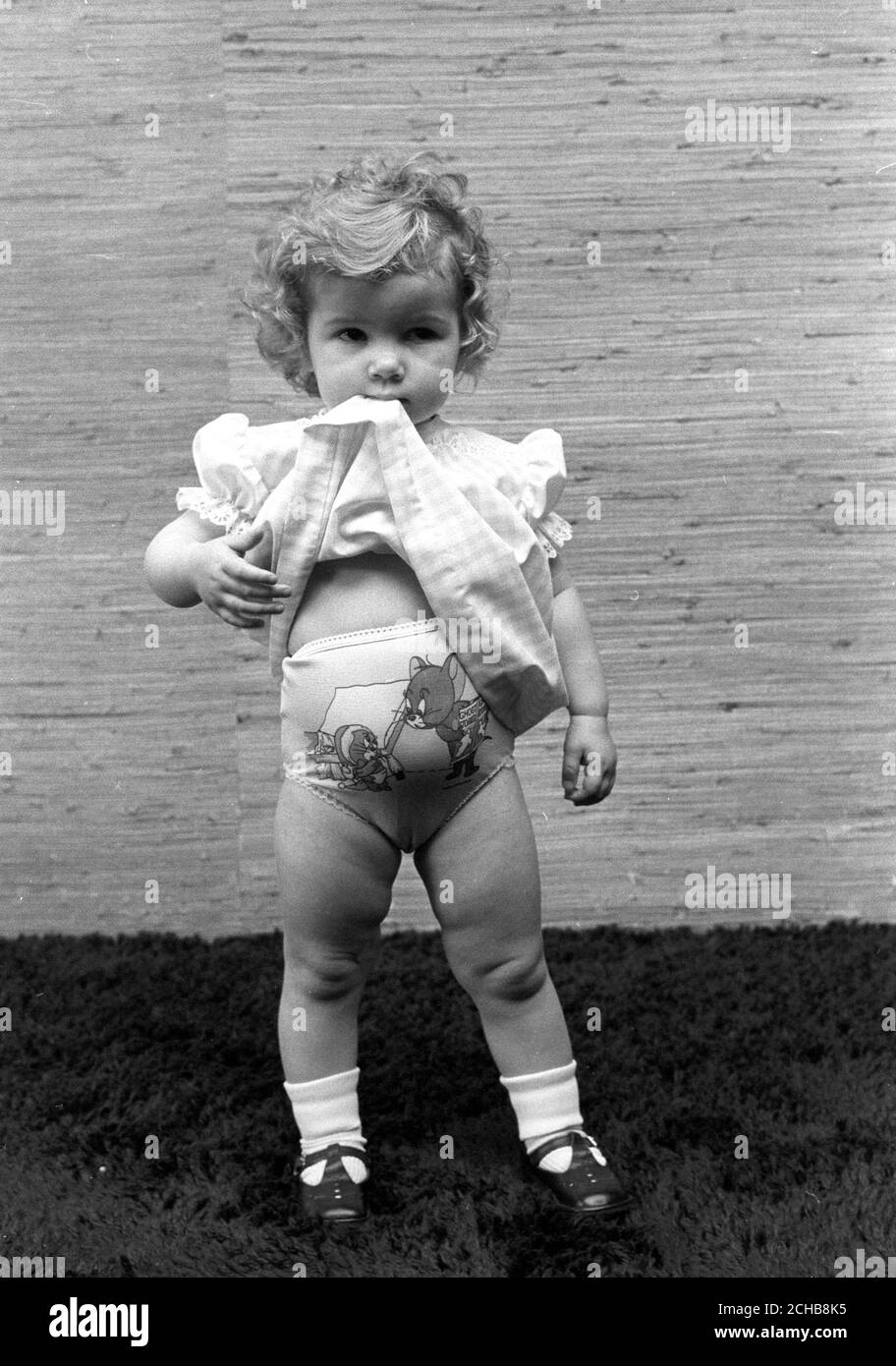 Cartoon-strip knickers featuring Tom and Jerry and a gingham baby dress are modelled by 18-month-old Kim Abraham at the British Home Stores fashion show at the Holiday Inn in London. Stock Photo