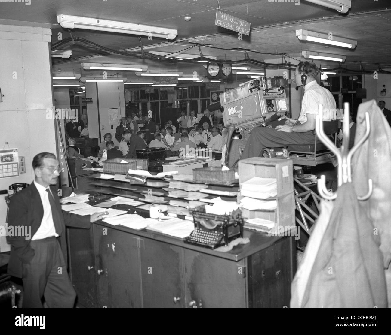 A BBC TV camera is seen on the Editorial floor of the Press Association, where staff are busy receiving the results of the 1959 General Election. A new computer will be used to calculate the implications of the voting, and from a handful of results, even venture to predict the ultimate result of the election. Stock Photo