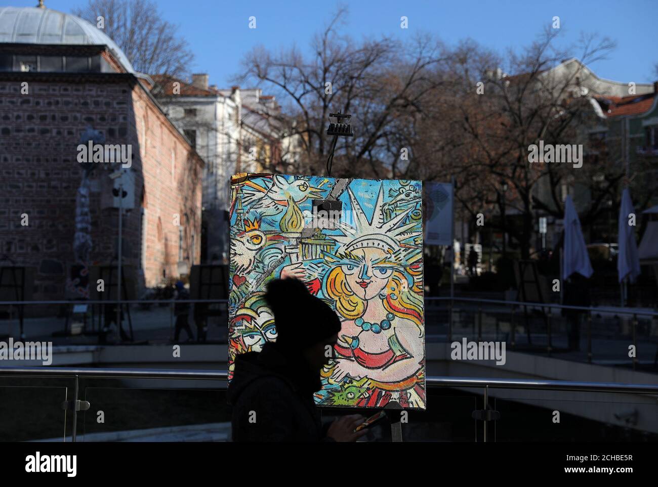A woman walks past an artpiece painted by French artist Christophe Bouchet on a section of the Berlin wall, as part of the 'Art Liberty, from the Berlin wall to the Street Art' exhibition, in Plovdiv, Bulgaria, January 12, 2019. REUTERS/Stoyan Nenov Stock Photo