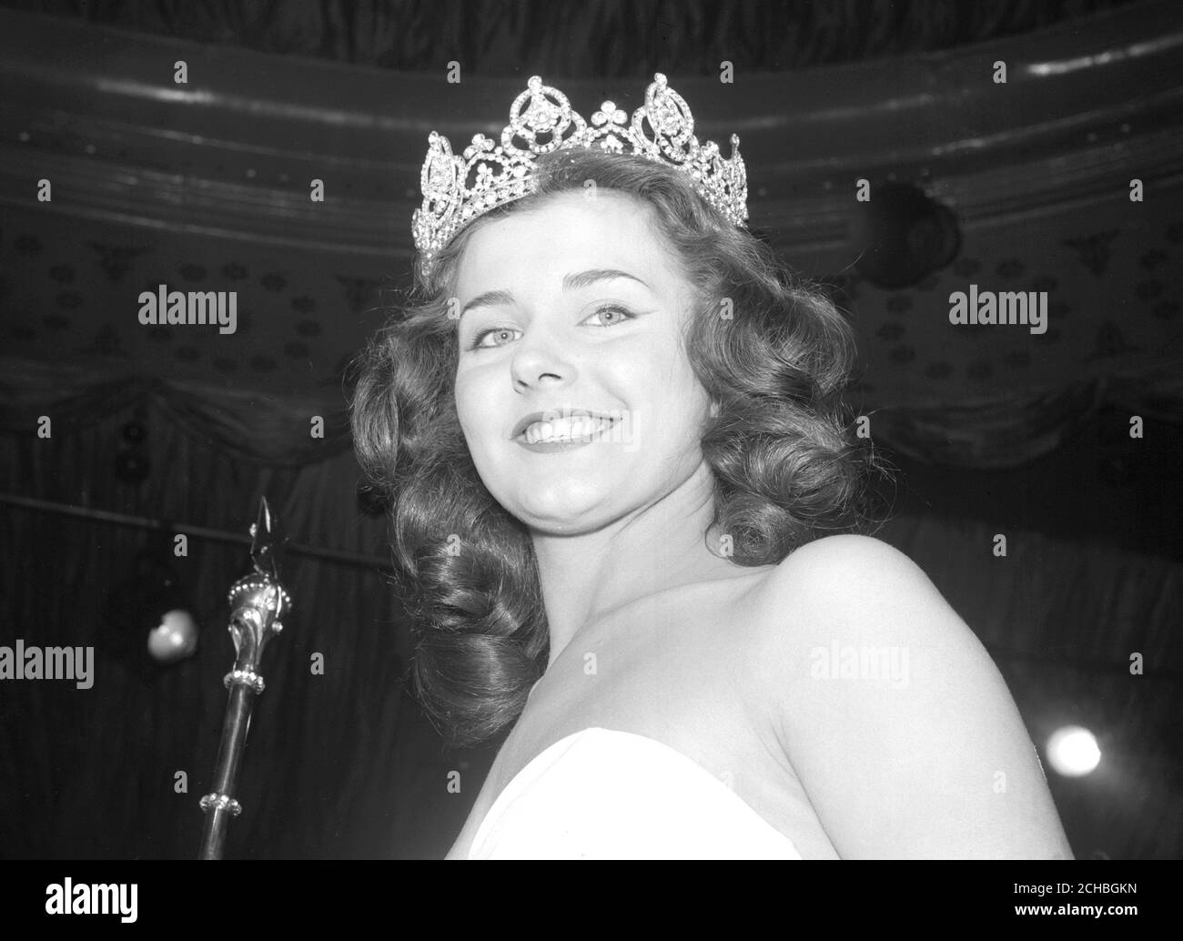 June Cooper, 16, a shop assistant from Sheffield, who has won the final of the Miss England competition at the Lyceum Ballroom, London. As Miss England, she will represent the country in the Miss Europe contest in Turkey, and the Miss Universe contest in California. Update 26/04/1958: June Cooper, 16, the Sheffield shop assistant who won the final of the Miss England competition at the Lyceum Ballroom last Tuesday. She has now resigned the title as her mother didn't wish her to go on a visit to America. Eric Morley, director of Mecca Ltd who organised the beauty contest, said a new election wo Stock Photo