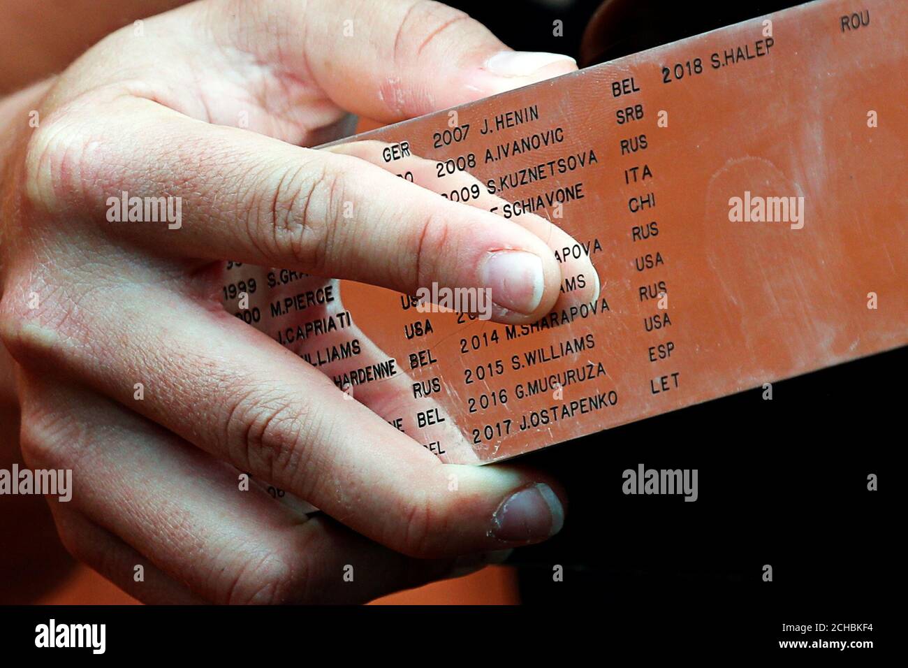 Tennis - French Open - Roland Garros, Paris, France - June 9, 2019. List of  former winners is seen on the Suzanne Lenglen's trophy as Australia's  Ashleigh Barty poses at the Roland