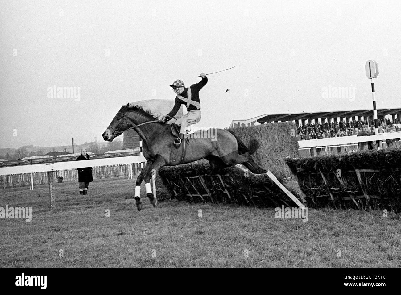 Top hurdler Persian War (B. Hicks) soars over the last flight to win by eight lengths in division one of the Kintbury Hurdle Race at Newbury. Stock Photo