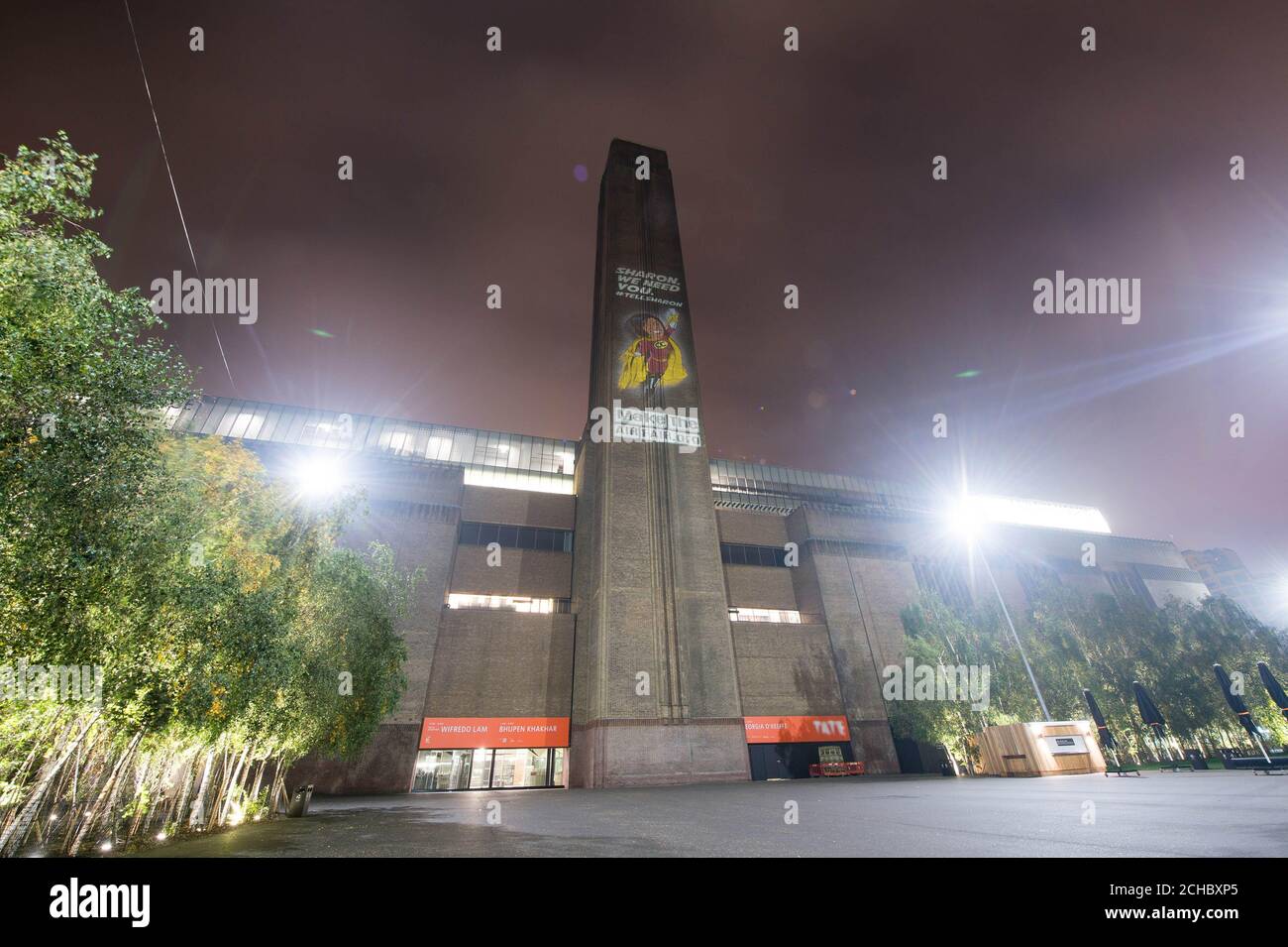 CEO of Ofcom Sharon White, dressed as a superhero, is projected onto the Tate Modern in London to launch the Make The Air Fair campaign. Stock Photo