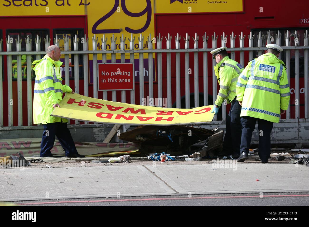 Police at the scene at Bromley Road in Bellingham, where five people have been left in hospital after they were run over by a car in London. Stock Photo