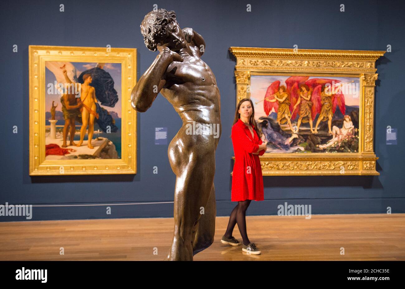 A visitor views 'The Sluggard' by Frederic Leighton (centre) during a photo call at the Tate Britain in London for their Queer British Art 1861 -1967 exhibition. Stock Photo