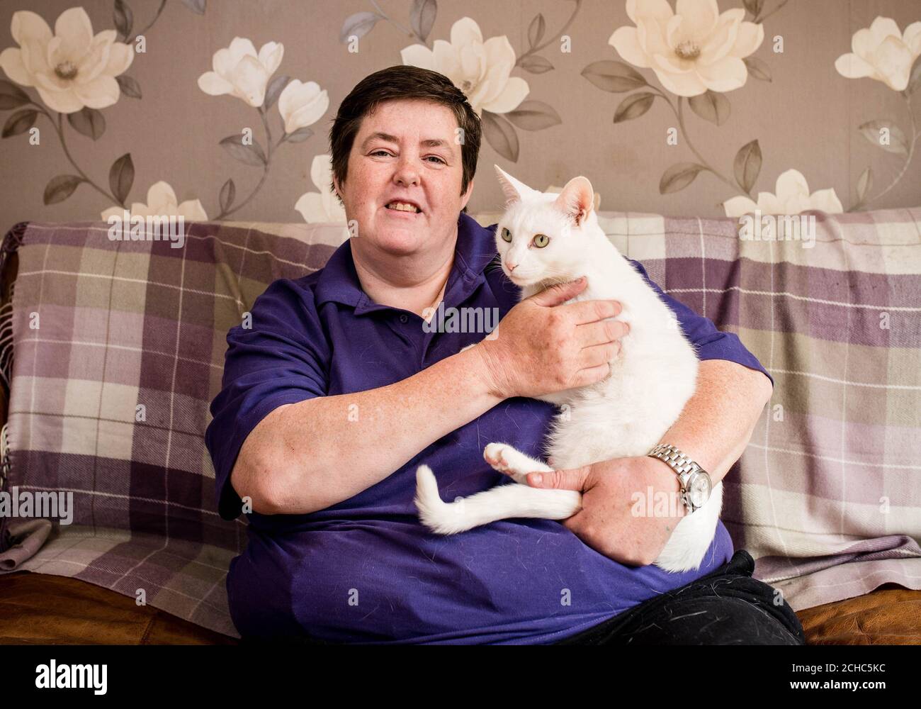 Jackie Kennedy from Poplar, London with her pet cat Lily, a Siamese cross British white, who has been nominated in the 'Hero Cat' category in this year's Cats Protection National Cat Awards, sponsored by Purina. Stock Photo