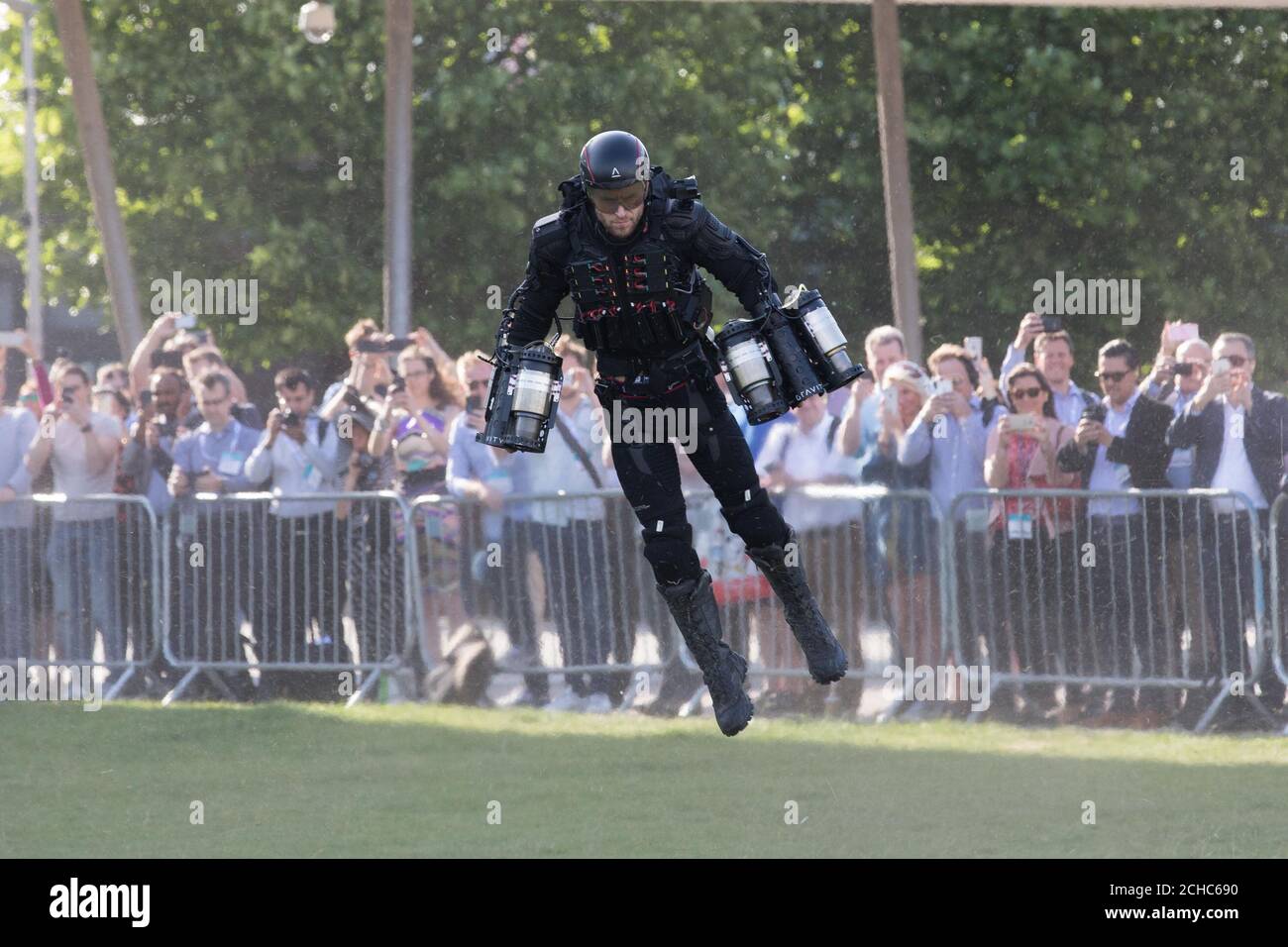 British inventor Richard Browning, known as the 'Real-life Iron Man', demonstrates his jet-powered flight suit as part of London Tech Week in Victoria Dock Square, London. Stock Photo